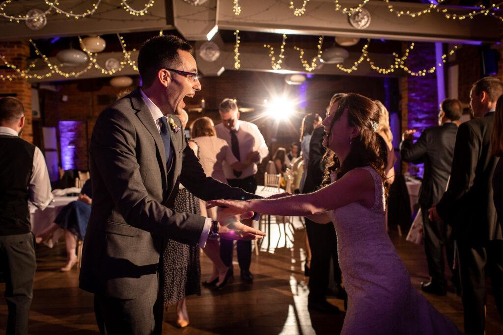 A happy couple dancing to a Lainston House Wedding DJ