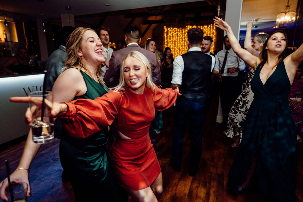 Happy wedding guests dancing to requests at Wickham Estate 