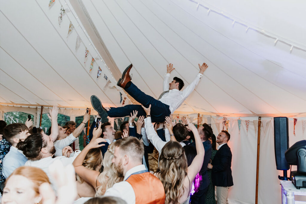 A crowdsurfing groom at a Hampshire Event DJ wedding